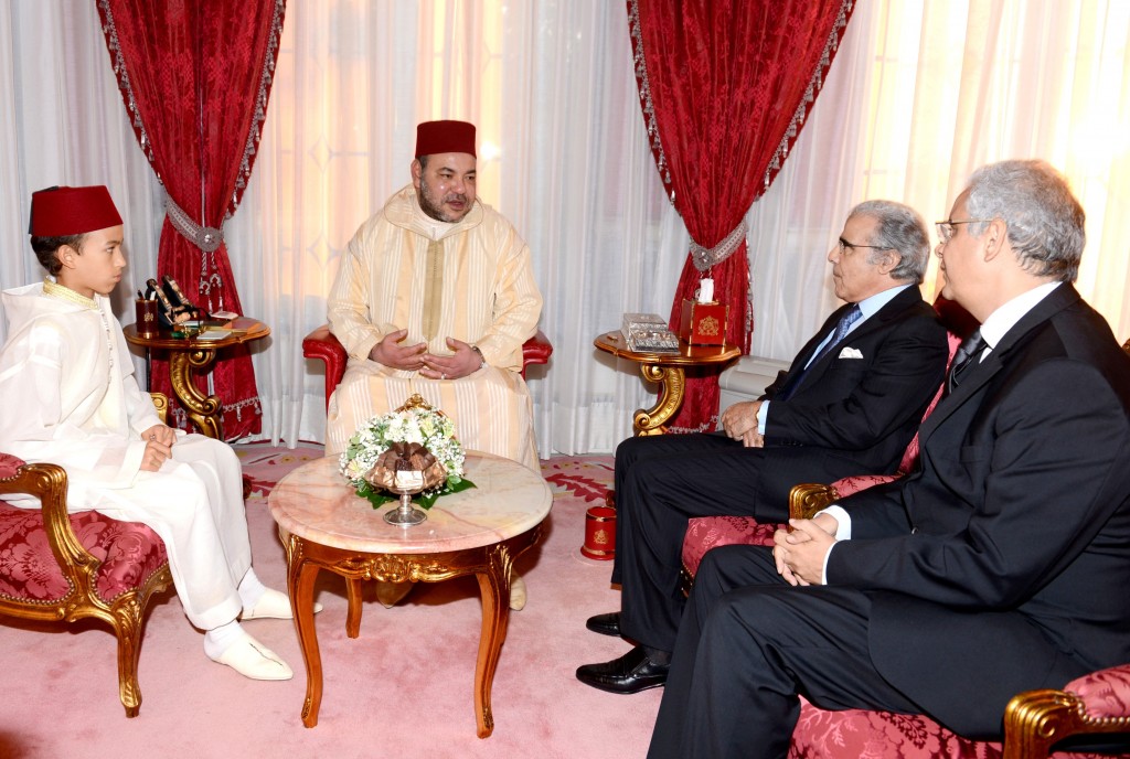 Morocco’s King Mohammed VI, accompanied by Crown Prince Moulay El Hassan, receives Nizar Baraka (far right), chairman of the Economic, Social and Environmental Council (CESE) and Abdellatif Jouahri, governor of Bank Al Maghrib. In his 15 year anniversary speech to the nation, the King called on CESE to carry out a study of Morocco’s wealth, its intangible capital and distribution, and provide recommendations.  July 30th, 2014.  Photo: MAP