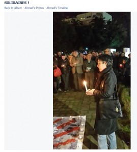 Soad Begdouri El Khammal lighting a candle in memory of the victims of the Charlie Hebdo attacks
